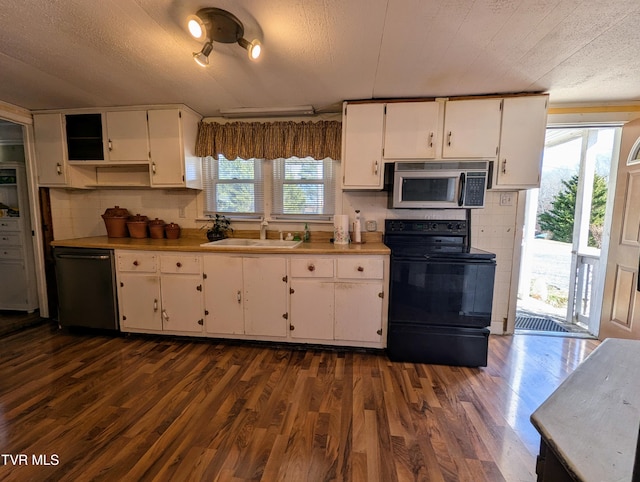 kitchen with sink, white cabinets, dark hardwood / wood-style floors, and black appliances