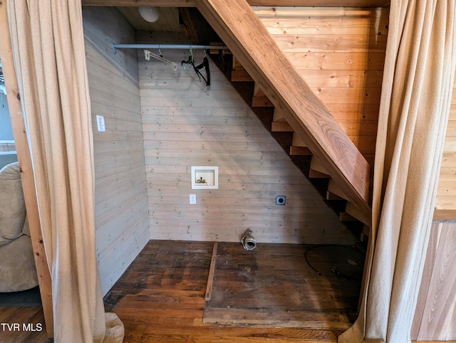 stairs featuring wood walls