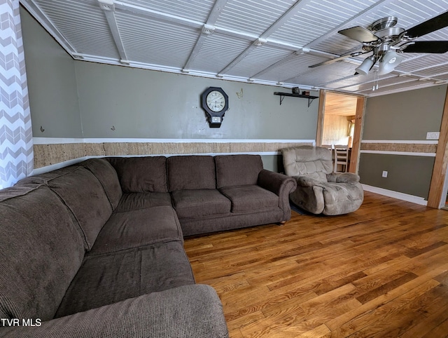 living room featuring hardwood / wood-style floors and ceiling fan