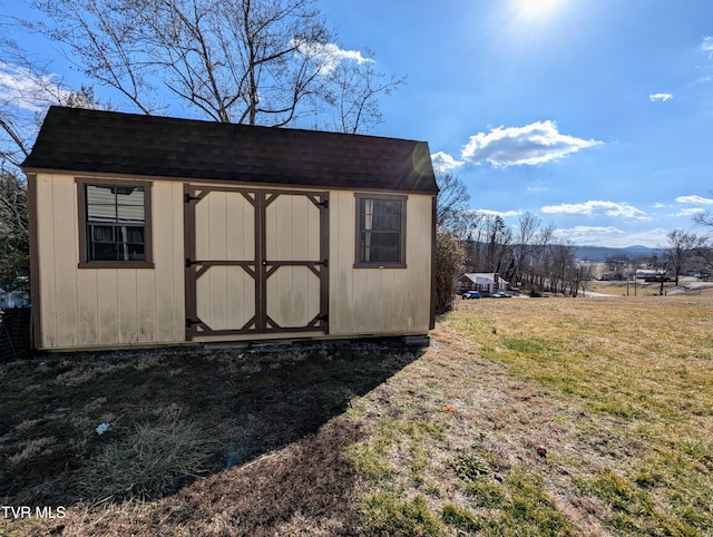 view of outbuilding with a yard