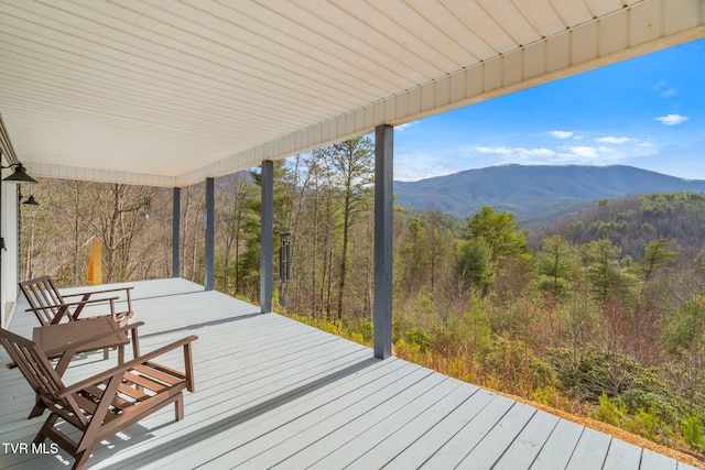 wooden deck with a mountain view