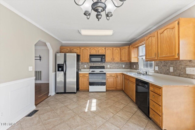 kitchen with light tile patterned flooring, sink, ornamental molding, decorative backsplash, and black appliances