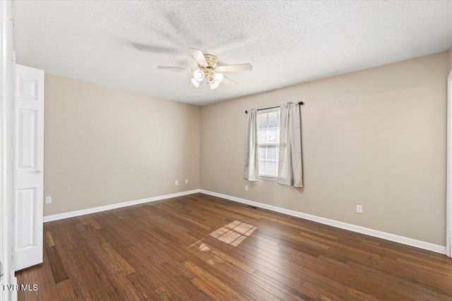 spare room featuring ceiling fan, dark hardwood / wood-style flooring, and a textured ceiling