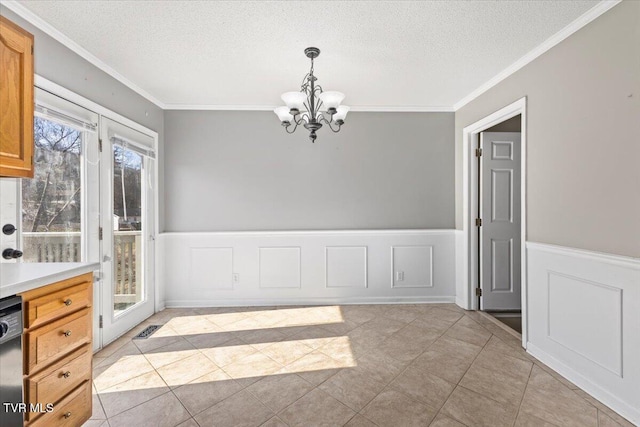 unfurnished dining area featuring crown molding, light tile patterned floors, a textured ceiling, and a notable chandelier