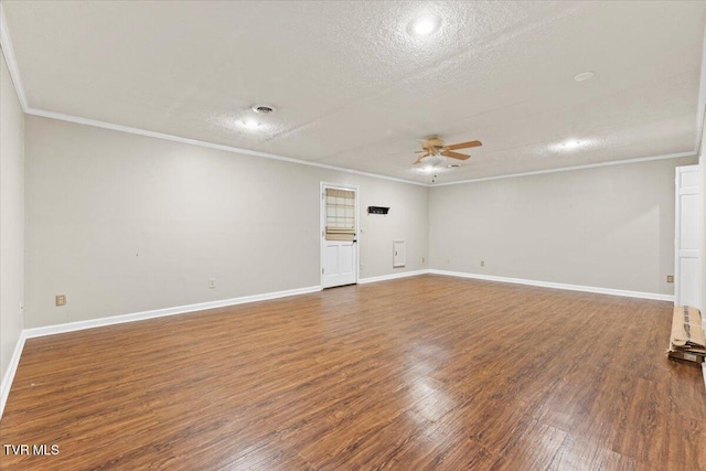 spare room with ornamental molding, dark hardwood / wood-style floors, a textured ceiling, and ceiling fan