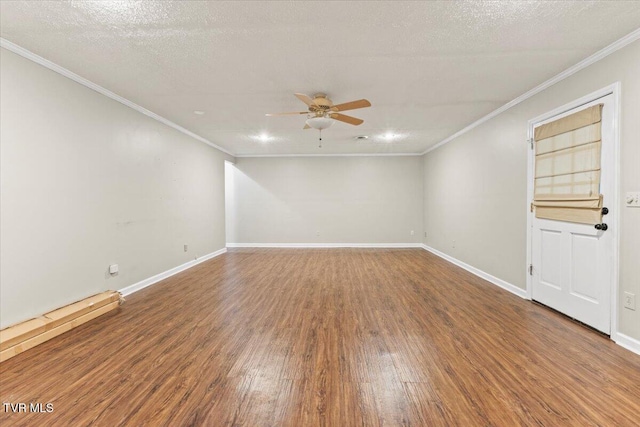 empty room featuring ceiling fan, wood-type flooring, ornamental molding, and a textured ceiling