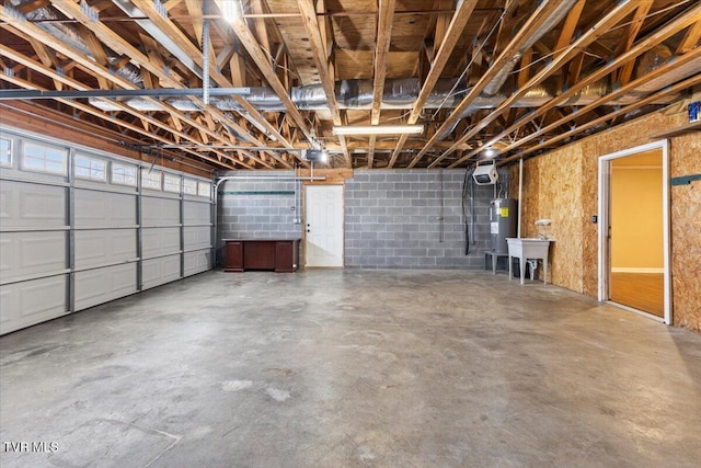 garage featuring sink and electric water heater