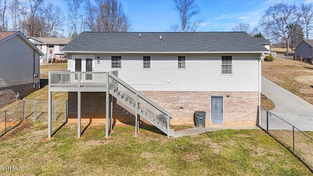 back of house featuring a yard and a deck