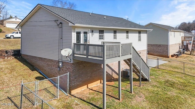 back of property featuring a deck, central AC unit, and a lawn