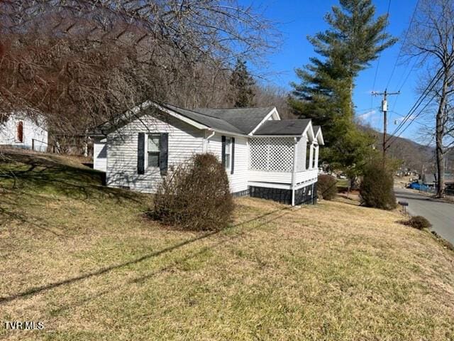 view of side of home featuring a yard