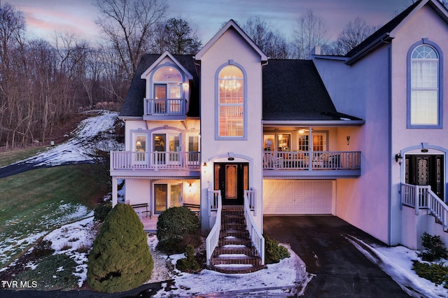 view of front of home featuring a balcony and a garage