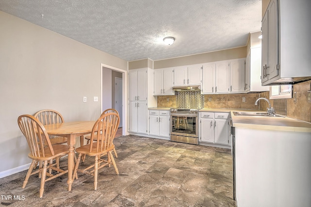 kitchen with sink, a textured ceiling, stainless steel stove, decorative backsplash, and white cabinets