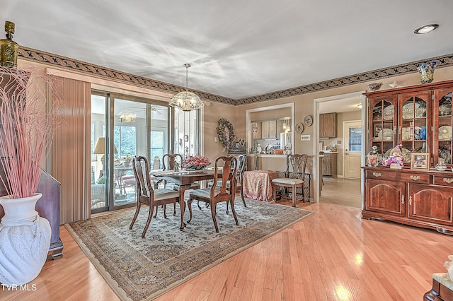 dining area with a chandelier and light wood-type flooring