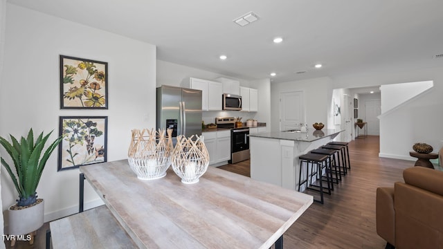 dining space featuring sink and hardwood / wood-style floors