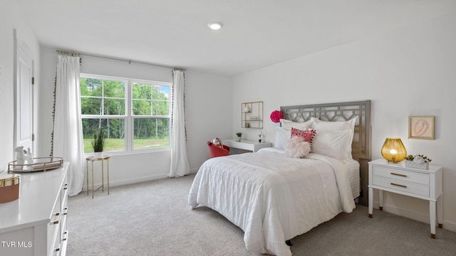 bedroom featuring light colored carpet