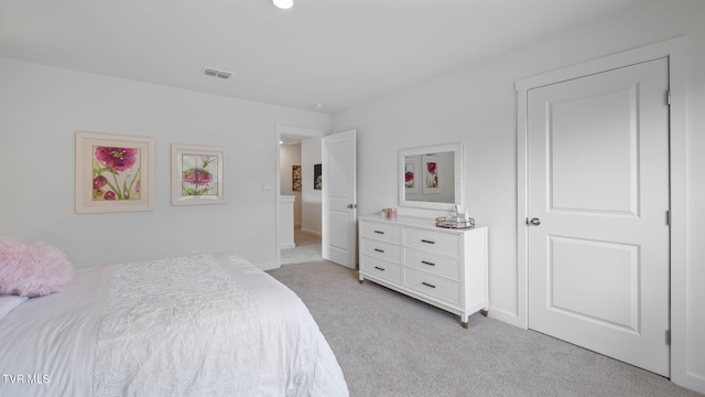 bedroom featuring light colored carpet