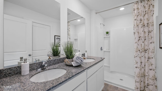 bathroom with vanity and walk in shower