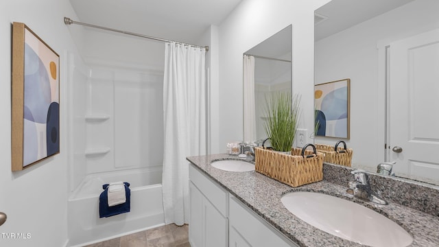 bathroom featuring vanity and shower / bathtub combination with curtain