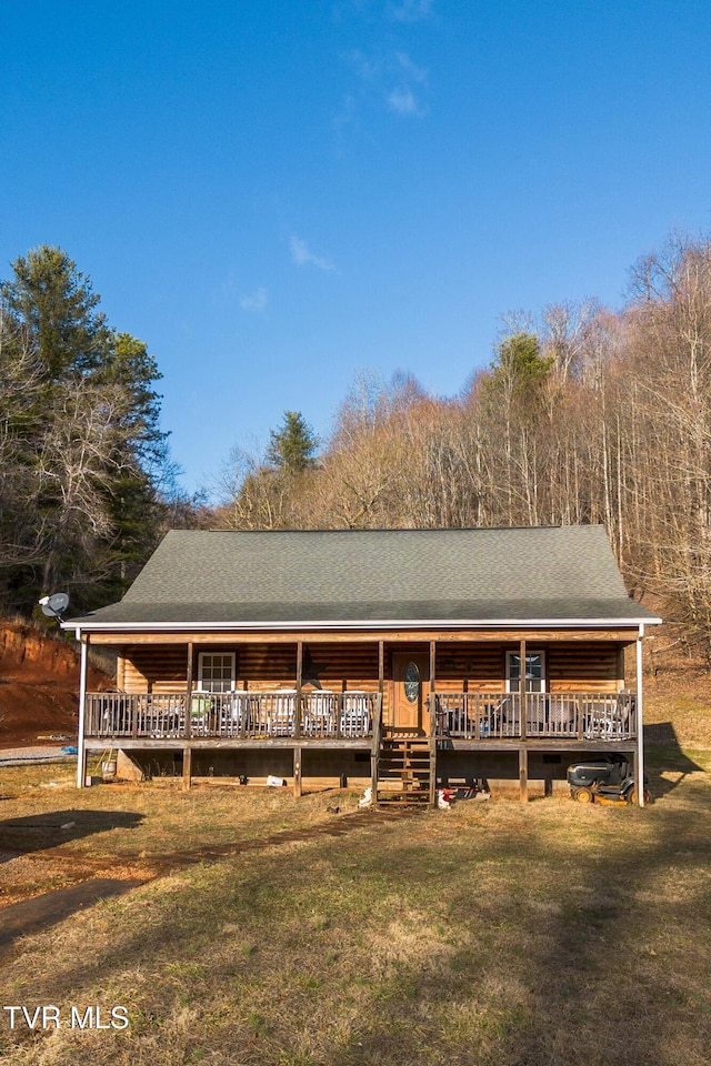 cabin with a front yard