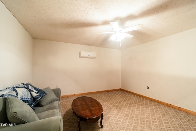 sitting room with ceiling fan, light colored carpet, a textured ceiling, and a wall unit AC