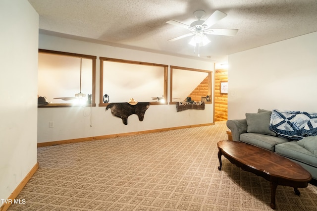 living room with light carpet, a textured ceiling, and ceiling fan