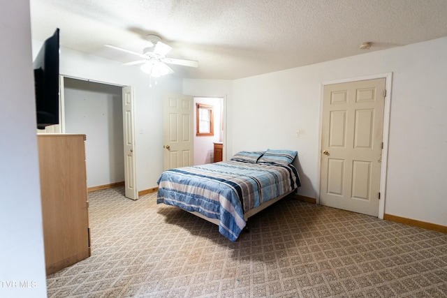 carpeted bedroom with ceiling fan and a textured ceiling