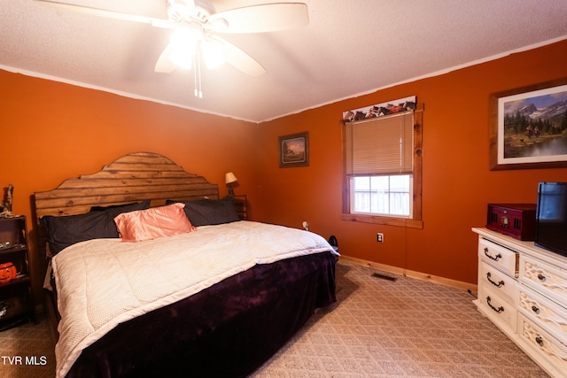 carpeted bedroom with crown molding and ceiling fan