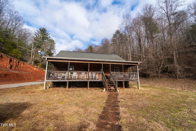 view of front of house with a front yard and a deck