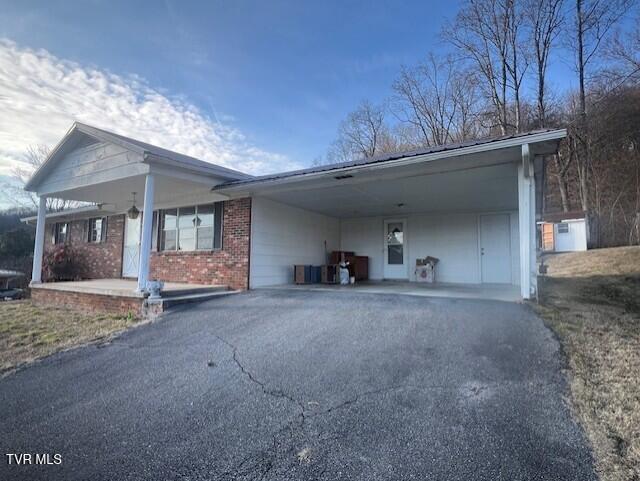 view of side of home with a carport