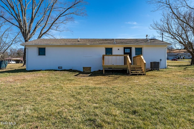 rear view of house with central AC unit, a lawn, and a wooden deck