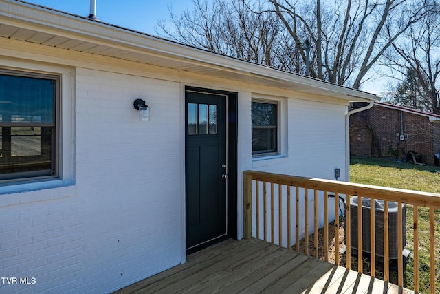 entrance to property with cooling unit and a deck