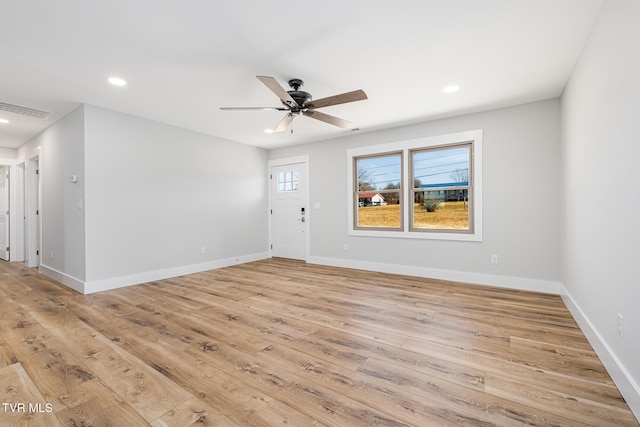 empty room with light hardwood / wood-style flooring and ceiling fan