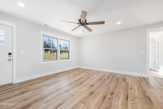 spare room with ceiling fan and light wood-type flooring