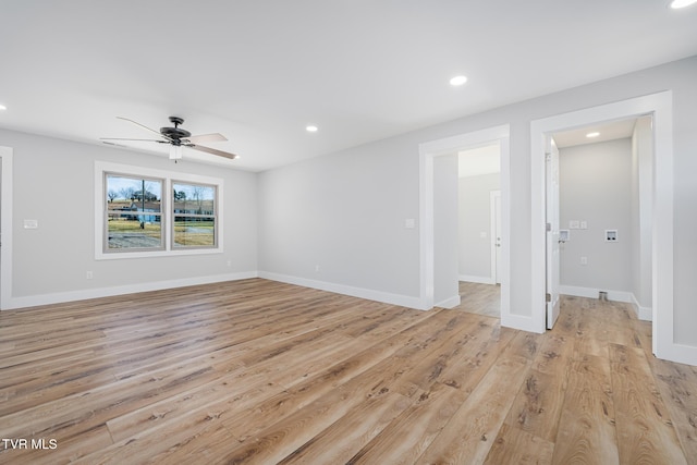 empty room featuring ceiling fan and light wood-type flooring