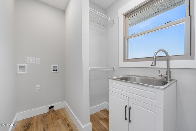 laundry area with washer hookup, sink, and light hardwood / wood-style flooring