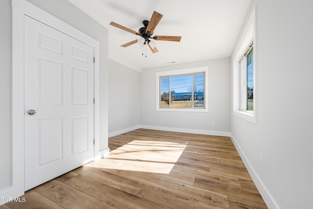 unfurnished bedroom with ceiling fan and light hardwood / wood-style flooring