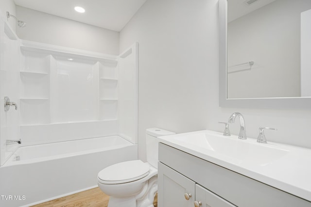 full bathroom featuring shower / tub combination, vanity, hardwood / wood-style floors, and toilet