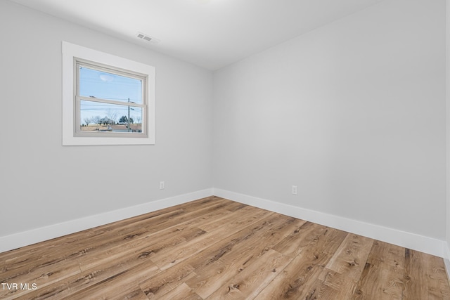 empty room with hardwood / wood-style flooring