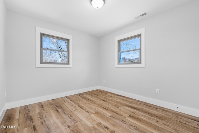 unfurnished room with light hardwood / wood-style flooring