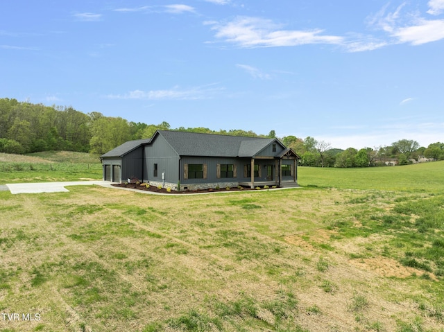 view of front of house featuring concrete driveway, an attached garage, and a front yard