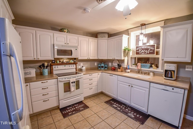 kitchen featuring pendant lighting, sink, white appliances, and white cabinetry