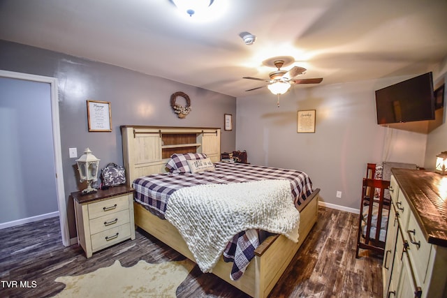 bedroom with ceiling fan and dark hardwood / wood-style flooring