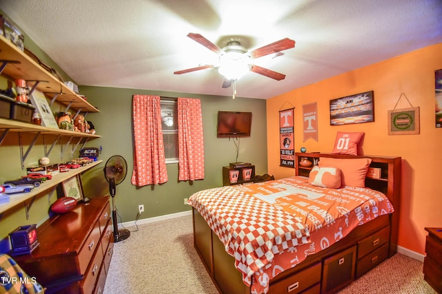 bedroom with ceiling fan, light carpet, and a textured ceiling