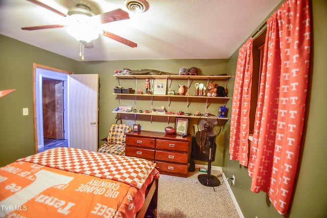 carpeted bedroom featuring a textured ceiling and ceiling fan