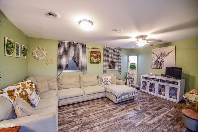 living room with wood-type flooring and ceiling fan