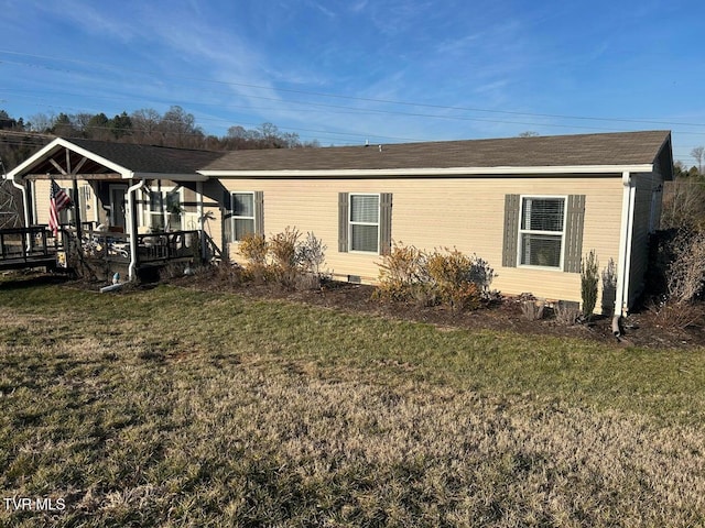 back of house featuring a yard