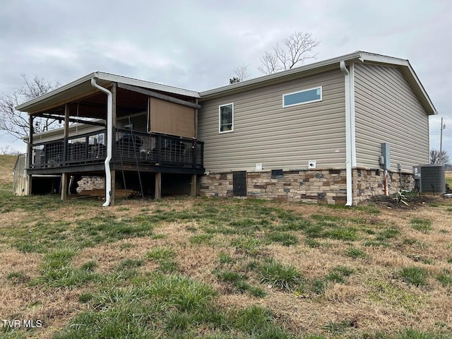 rear view of property with a yard and a deck