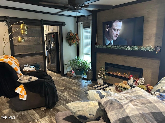 living room with ceiling fan and wood-type flooring