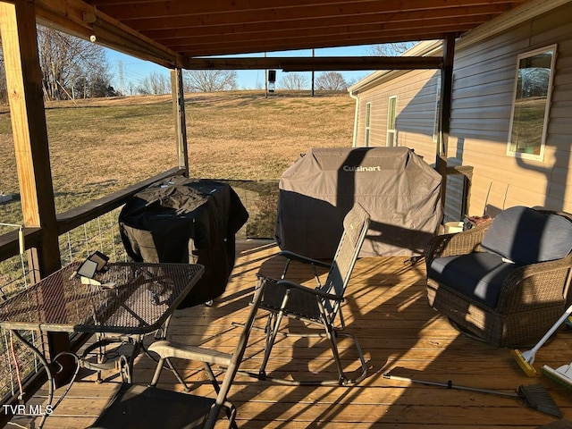 deck featuring a rural view and a lawn