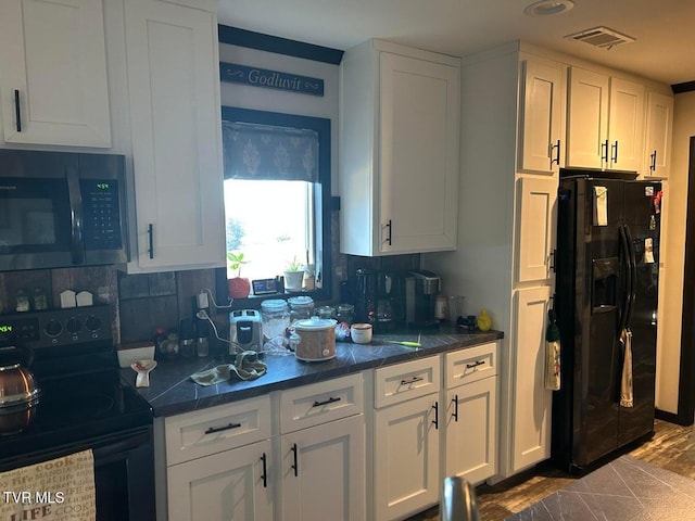 kitchen featuring tasteful backsplash, white cabinetry, and black appliances